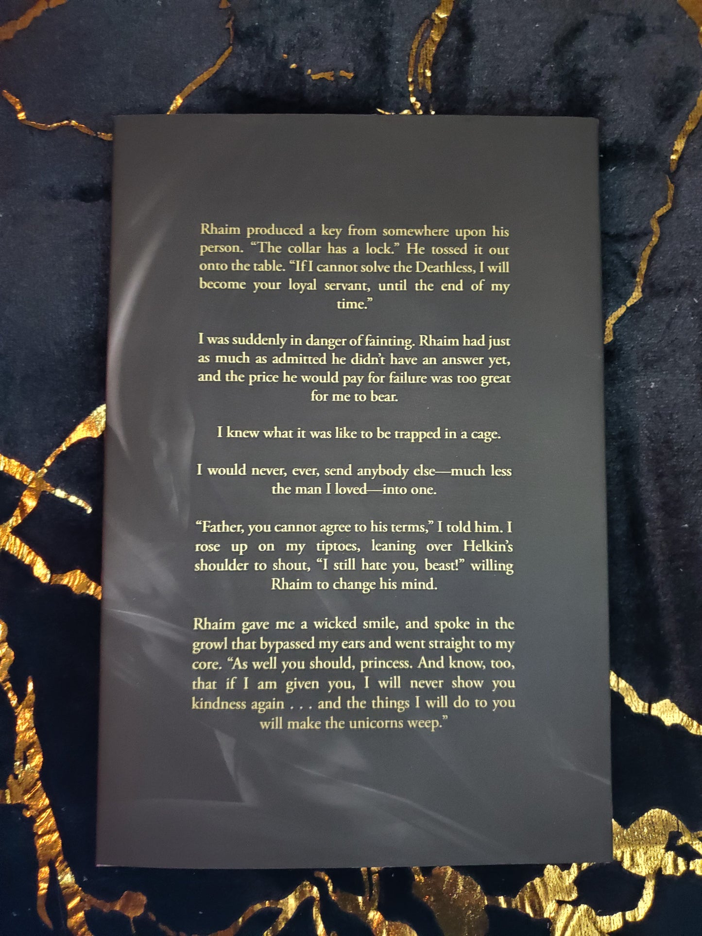 Hardcover of Make Her by Cassie Alexander on a black and gold background. Shows the back cover.