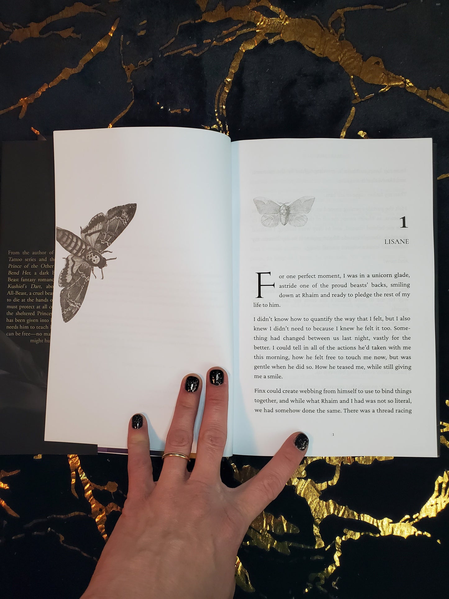 Two page spread from the interior of Make Her by Cassie Alexander. Shows the first chapter. The left page has a moth illustration. The chapter has another moth illustration.