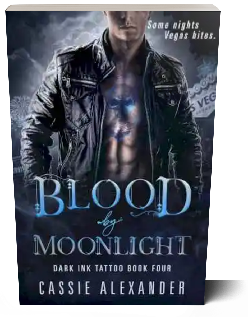 Cover for Blood by Moonlight: Dark Ink Tattoo Book Four by Cassie Alexander. A man wearing a black leather jacket with a blue skull tattoo on his chest stands in front of a Las Vegas skyline. Tagline reads: Some nights Vegas bites. Shown as a paperback book.